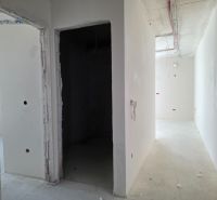 Unplastered walls and exposed electrical wiring in a 3-room apartment.