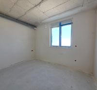 A room in a 3-room apartment with white walls and a window.