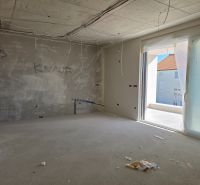 Under-construction 3-room apartment with a view of the terrace, unfinished walls, and electrical installation.