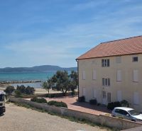 A view of a 3-room apartment in the town of Srima near the coast with a car.