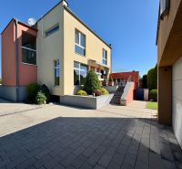 A family house in Partizánske with a garden, terrace, and garage on a paved yard.
