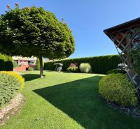 A well-maintained garden with a gazebo at a family house in Partizánske.