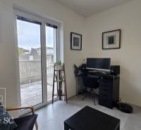 A workspace in a family house with a view of the terrace, wooden decor flooring.
