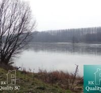 River by the shore at the Old Port Gabčíkovo, Residential land, surrounded by trees.