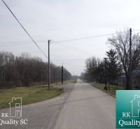 A beautiful road in the Old Port of Gabčíkovo for living, surrounded by trees on the plots.