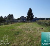 Plots - residential area on Vrbová Street in Jelka with a grassy area and fencing.