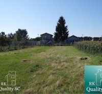 Residential plots in Galanta on Jelka - Vrbová Street, with a grassy area and a tree.