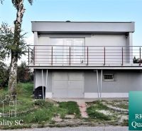 A cottage at SUNNY LAKES SOUTH in Senec with a balcony and surrounding lawn.