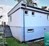Cottage at SUNNY LAKES SOUTH in Senec with a staircase and a light facade.