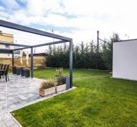 The garden of a family house at Sunny Lakes South in Senec with a terrace and lawn.