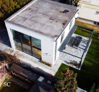 A family house at Sunny Lakes South in Senec with large windows and a terrace.