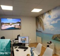 Interior of a family house with beach decor, table, and computers.