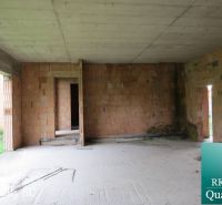 Interior of a family house with brick walls and concrete floor, suitable for renovation.