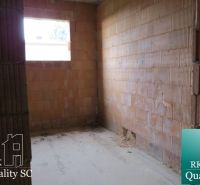 Interior of a family house with a rough construction and brick walls.