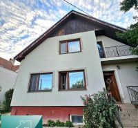 A family house in Tureň on Tureň Street with a white facade and a garden.