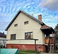 A family house in the town of Tureň on Tureň Street, with a grassy garden and a clothes dryer.