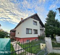 A family house in the village of Tureň on Tureň street, surrounded by greenery and fencing.