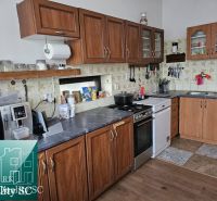 A kitchen in a family house with a wooden floor decor, kitchen units, and appliances.