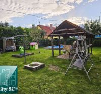 The garden of a family house in Tureň with a gazebo, swing, and children's playground on Tureň street.