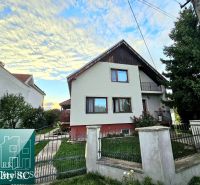 A family house in Tureň on Tureň Street with a fenced garden and a blue sky.