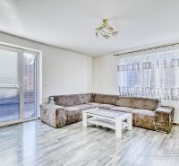 Living room in a family house with a sofa and a table, floor with wooden decor.