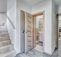 A staircase with marble tiles and a floor with wooden decor in a family house.