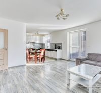 Interior of a family house with an open kitchen and living room, floor with wooden decor.