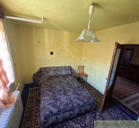 A room with a sofa, chair, carpet, and curtains. A stylish interior of a family house.