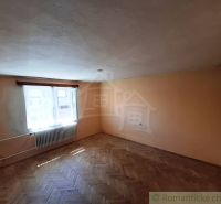A room with a wooden decor floor and a radiator in a family house.