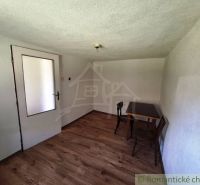 A simple room in a family house with wooden decor flooring.