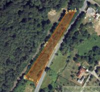 Plots - housing in Šiatorská Bukovinka surrounded by greenery and road network.