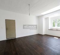 A space with white walls and a wooden decor floor in a 3-room apartment.
