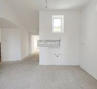 The interior of a spacious 3-room apartment with white walls and a small window.