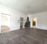 A room in a 3-room apartment with a wooden decor floor and smooth white walls.