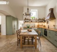 A kitchen in a 3-room apartment with a dining table and vintage kitchen decor.