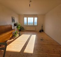 A bright room with a piano and a wooden decor floor in a 4-room apartment.
