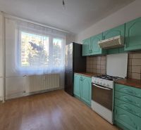 A kitchen with a gas stove, green cabinets, and a wood-patterned floor in a 4-room apartment.