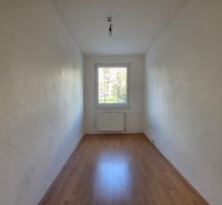 An empty room with a wooden decor floor in a 4-room apartment.