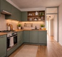 A kitchen in a 4-room apartment with a wooden decor floor and green cabinets.