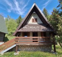 A cottage in Chyžné surrounded by forest and blue sky, suitable for relaxation.