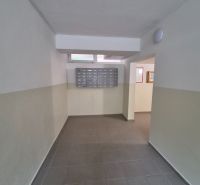 A hallway with mailboxes in a 2-room apartment.