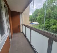 A glazed balcony of a 2-room apartment with a view of the forest in Trenčianske Teplice, Štvrt SNP.