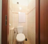 Bathroom in a 2-room apartment with tiles and a toilet.
