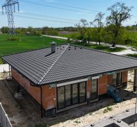 A family house with a flat roof in Bernolákovo surrounded by green fields.