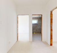 White walls and raw door openings in the family house.