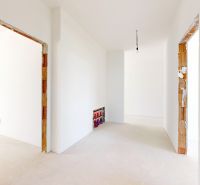 The interior of a family house with white walls and preparations for electrical installations.