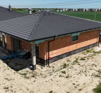A family house in Bernolákovo with a brick facade and a dark roof.