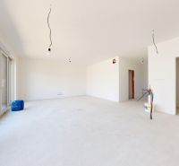 Under-construction interior of a family house with large windows and a spacious room.