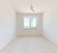 Empty room with white walls, white ceiling, single-window view in a family house.