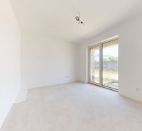 A white empty room with a large window in a family house.